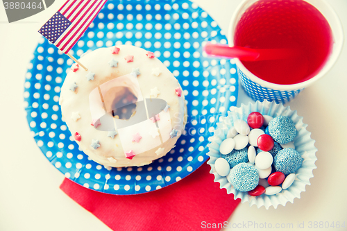 Image of donut with juice and candies on independence day