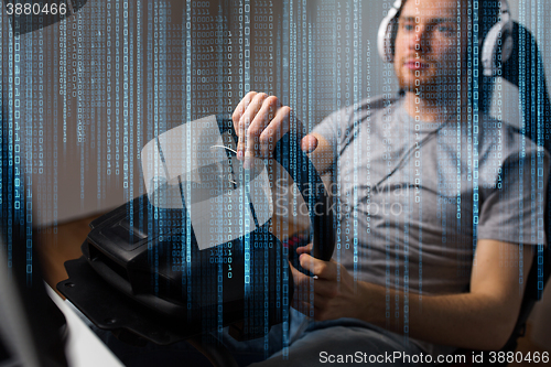 Image of close up of man playing car racing video game