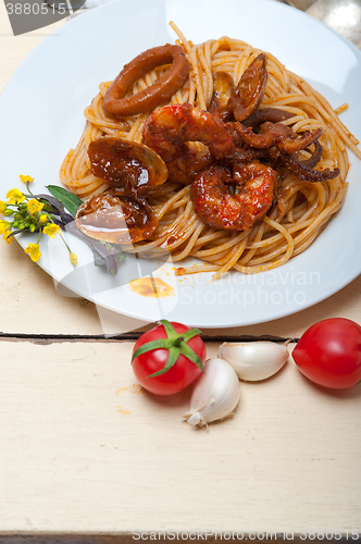 Image of Italian seafood spaghetti pasta on red tomato sauce 