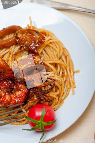 Image of Italian seafood spaghetti pasta on red tomato sauce 