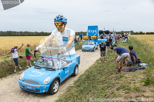 Image of Krys Caravan on a Cobblestone Road- Tour de France 2015