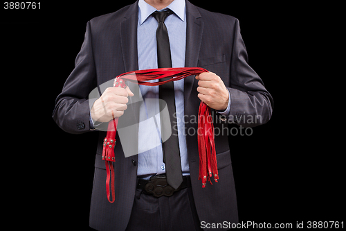 Image of man in business suit with chained hands. handcuffs for sex games