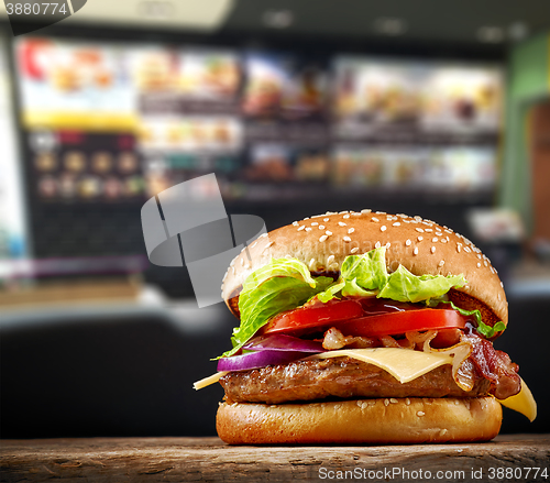 Image of fresh tasty burger on wooden table