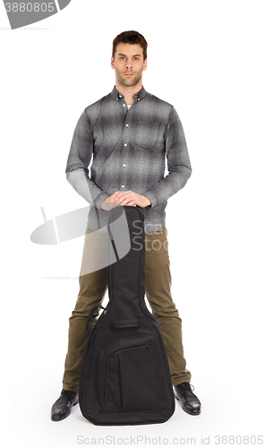 Image of Musican with acoustic guitar in bag