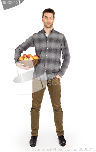 Image of Healthy man with bowl full of apples