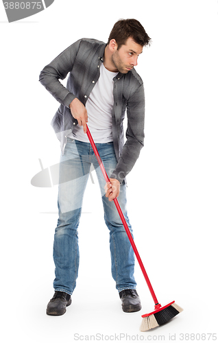 Image of Young worker with a broom