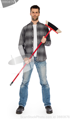 Image of Young worker with a broom