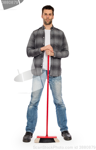 Image of Young worker with a broom