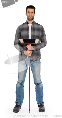 Image of Young worker with a broom