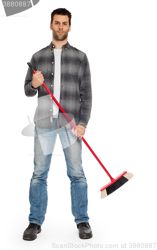 Image of Young worker with a broom