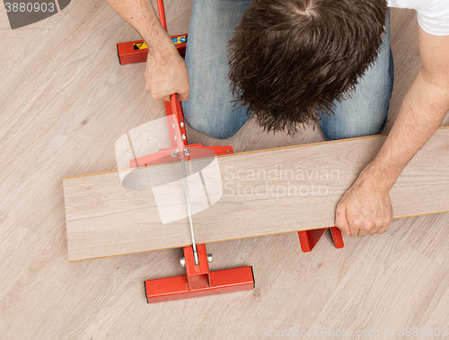 Image of Red tool for cutting laminate