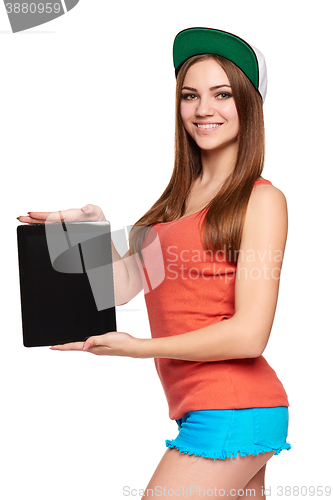 Image of Smiling hip teen girl showing black blank digital tablet screen