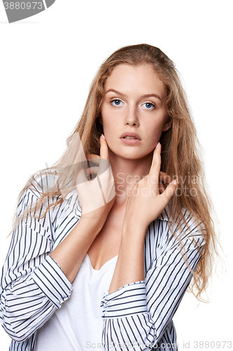 Image of Beautiful smiling girl touching her face