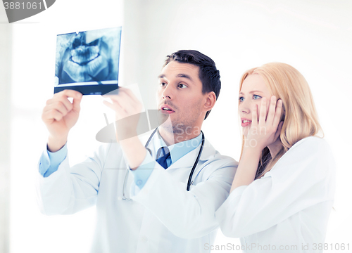 Image of two doctors looking at x-ray