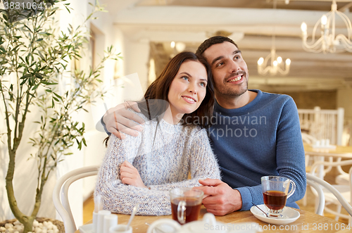 Image of happy couple drinking tea at restaurant