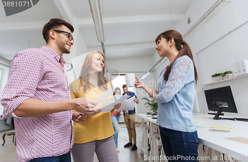 Image of creative team on coffee break talking at office