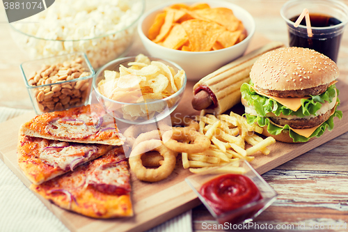 Image of close up of fast food snacks and drink on table