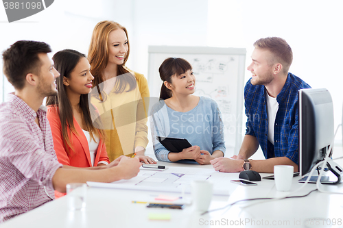 Image of happy creative team or students working at office