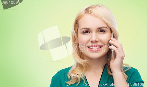Image of happy young woman calling on smartphone