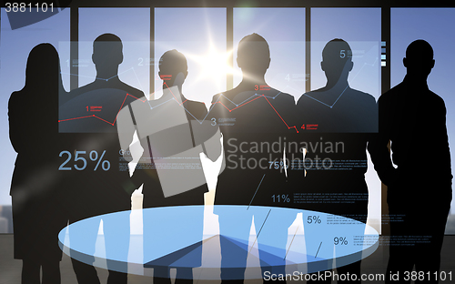 Image of business people silhouettes with pie chart