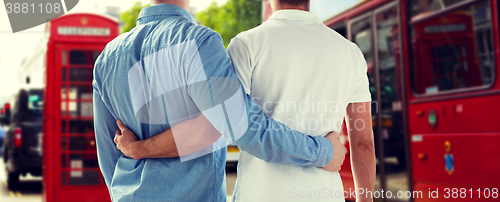 Image of close up of gay couple hugging over london city