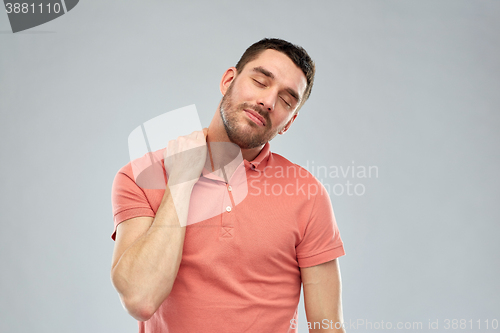 Image of unhappy man suffering from neck pain