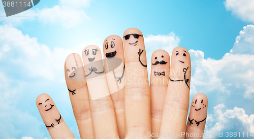 Image of close up of hands and fingers with smiley faces