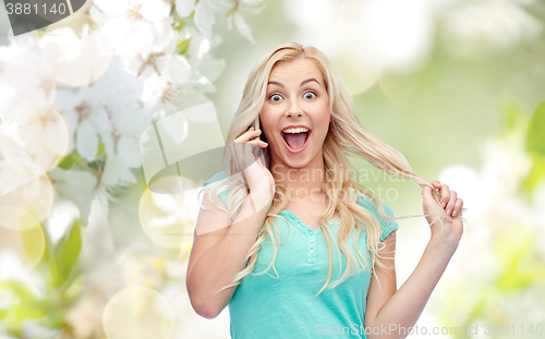 Image of smiling young woman calling on smartphone