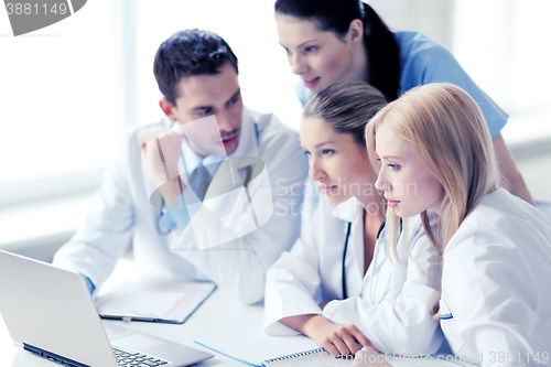 Image of group of doctors looking at tablet pc