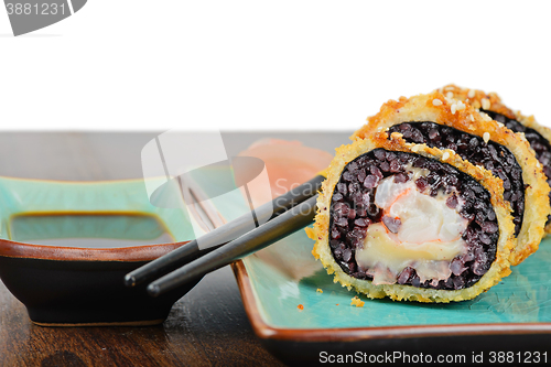 Image of Baked sushi rolls served on turquoise plate