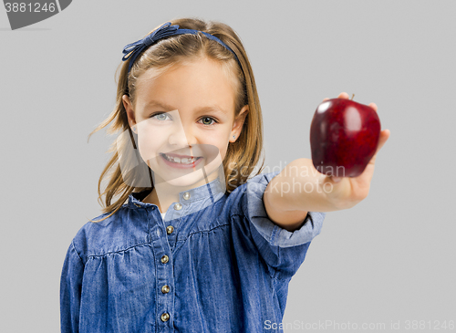 Image of Cute girl holding an apple