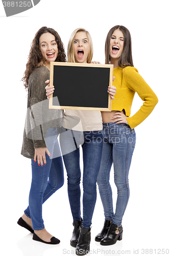 Image of Teenage girls holding a chalkboard