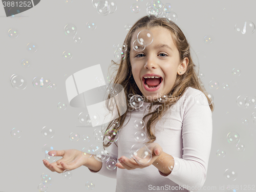 Image of Girl playing with soap bubbles