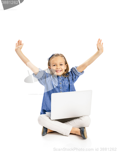 Image of Little girl working with a laptop