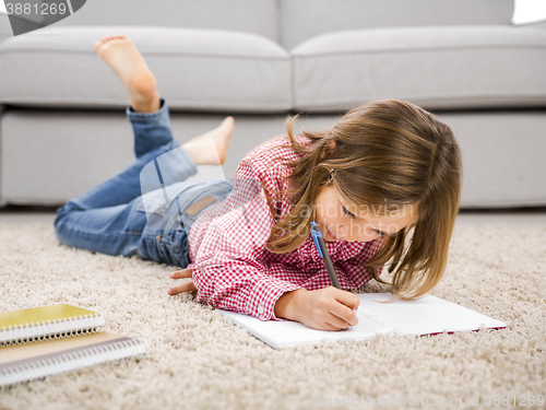 Image of Little girl making homework