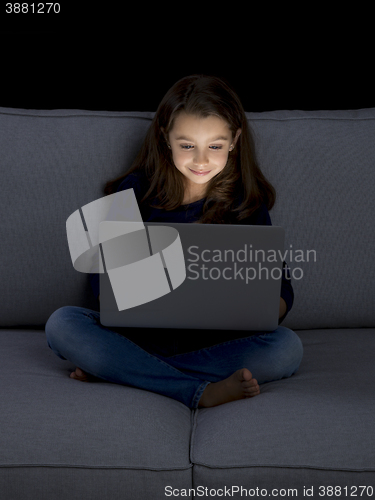 Image of Little girl working with a laptop