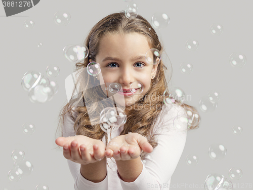 Image of Girl playing with soap bubbles