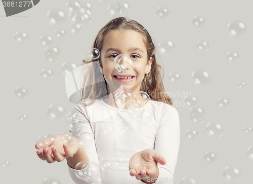 Image of Girl playing with soap bubbles