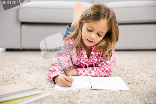 Image of Little girl making homework