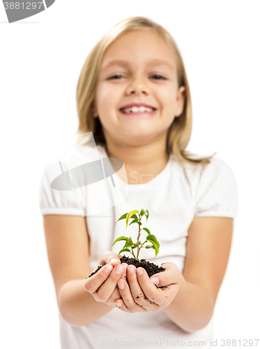 Image of Cute girl showing a plant