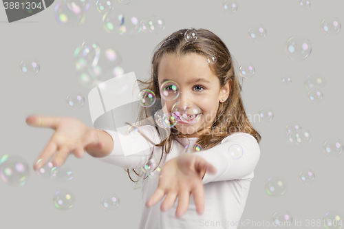 Image of Girl playing with soap bubbles