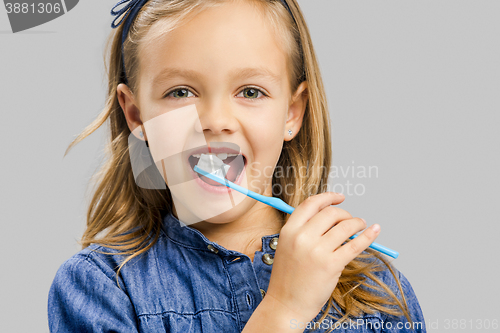 Image of Little girl brushing teeth