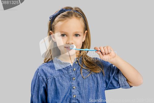 Image of Little girl brushing teeth