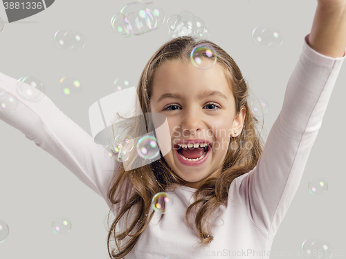 Image of Girl playing with soap bubbles