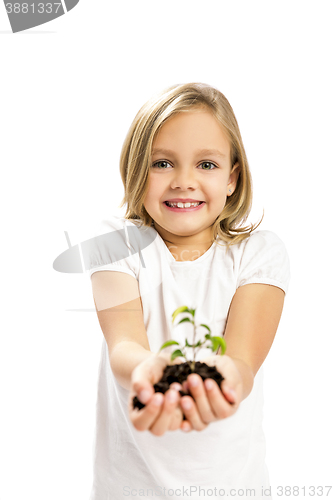 Image of Cute girl showing a plant