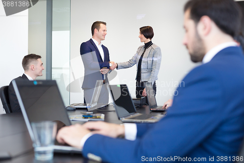 Image of Business people shaking hands.