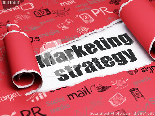 Image of Marketing concept: black text Marketing Strategy under the piece of  torn paper