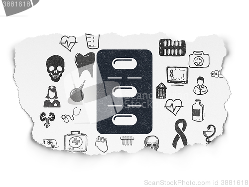 Image of Health concept: Pills Blister on Torn Paper background