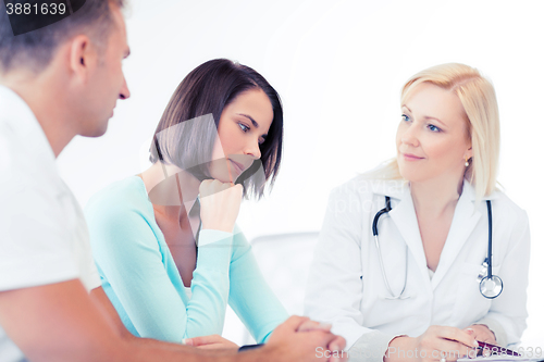 Image of doctor with patients in cabinet