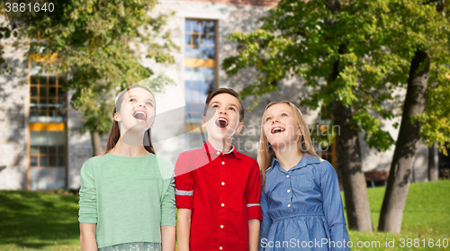 Image of amazed children looking up over summer campus